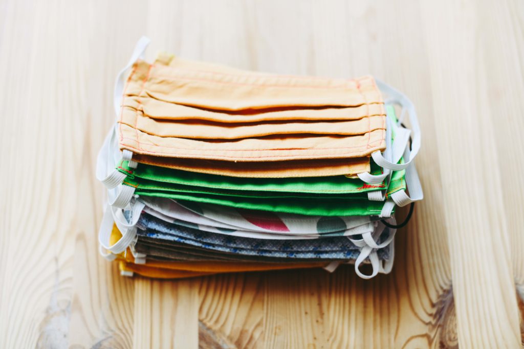 Stack of colorful, handmade cloth face masks